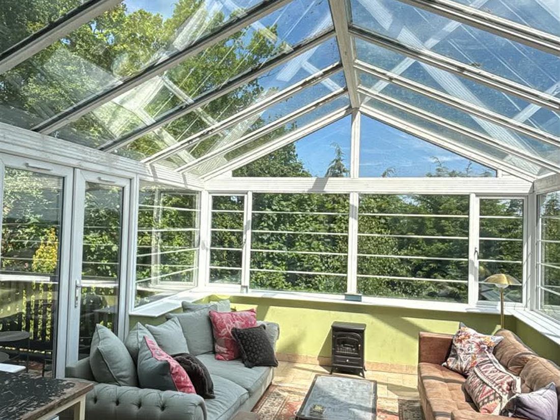 Conservatory roof glass before cleaning with dirt and debris visible