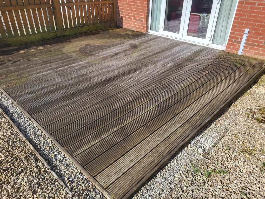 Timber decking before cleaning, green and weathered
